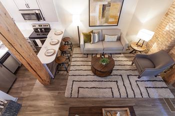 Elevated view of living room and high ceilings from staircase to second floor